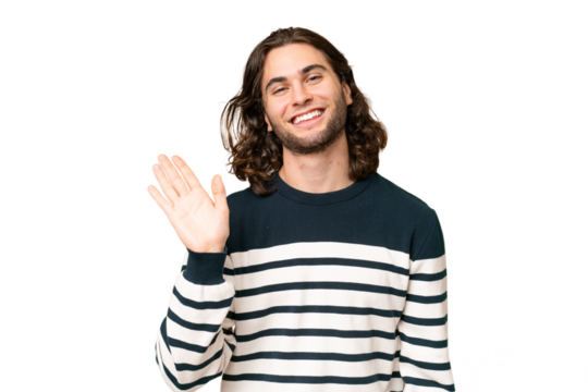 Young handsome man over isolated background saluting with hand with happy expression