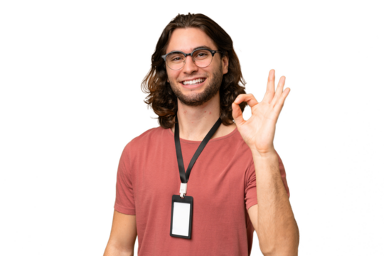 Young handsome man with ID card over isolated background showing ok sign with fingers