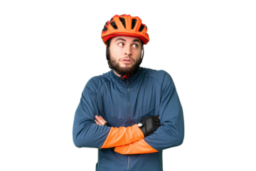 Young cyclist man over isolated chroma key background making doubts gesture while lifting the shoulders