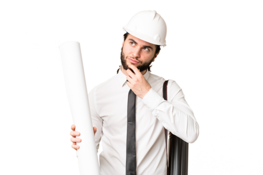 Young architect man with helmet and holding blueprints over isolated chroma key background and looking up