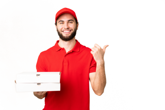 pizza delivery man with work uniform picking up pizza boxes over isolated chroma key background pointing to the side to present a product - Powered by Adobe