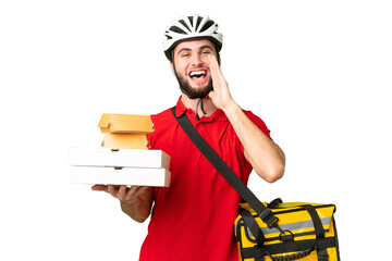 Young delivery man with thermal backpack over isolated chroma key background shouting with mouth wide open