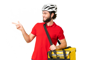 Young delivery man with thermal backpack over isolated chroma key background pointing finger to the side and presenting a product