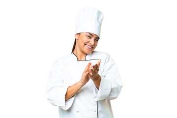 Young woman Chef over isolated chroma key background applauding after presentation in a conference