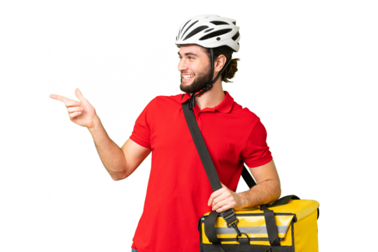 Young delivery man with thermal backpack over isolated chroma key background pointing finger to the side and presenting a product