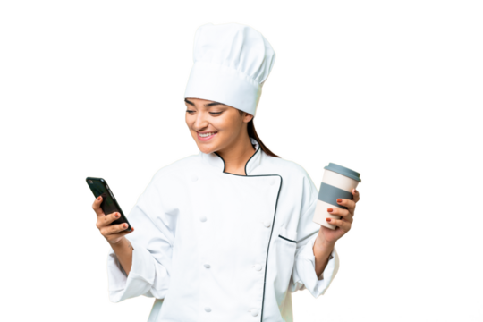 Young woman Chef over isolated chroma key background holding coffee to take away and a mobile