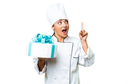 Woman pastry chef with a big cake intending to realizes the solution while lifting a finger up