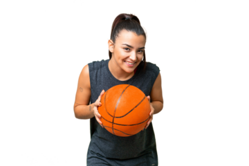 Young beauty woman over isolated chroma key background playing basketball