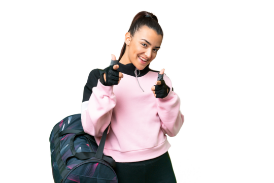 Young sport woman with sport bag over isolated chroma key background pointing to the front and smiling