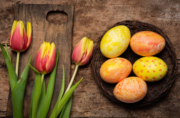 Easter Eggs and Tulips on Rustic Wooden Table for Home Decoration