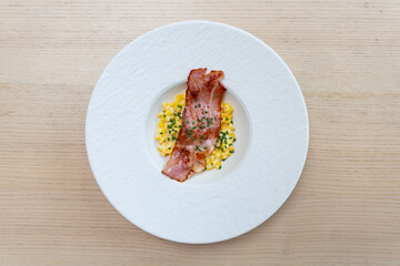 Creamed corn with bacon on top.