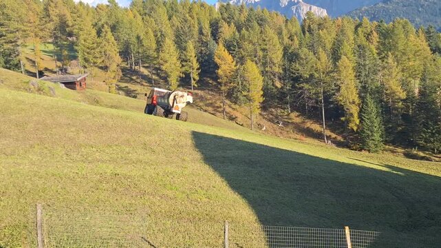 The manure spreader machine spreads fertilizer evenly over the field.