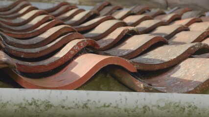 Terracotta roof tiles on a house roof sliding camera motion close up stock footage - Powered by Adobe