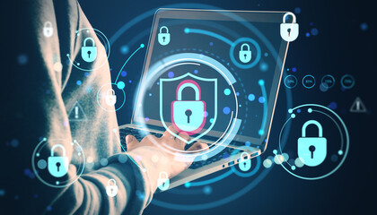 Cybersecurity concept with glowing padlock symbols and holographic icons around a person using a laptop for secure online data protection.