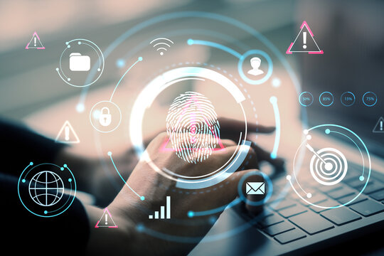 Person using laptop with digital fingerprint and cybersecurity interface over light background, emphasizing secure identity and data protection..