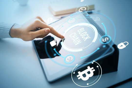 Person interacting with blockchain cryptocurrency interface on digital tablet with futuristic display and financial icons in light abstract background. - Powered by Adobe