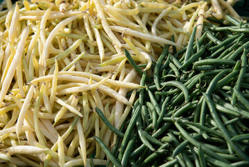 Fresh green and yellow beans arranged in a food market. Healthy vegetarian lifestyle