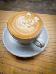 Cup of cappuccino with heart shaped latte art