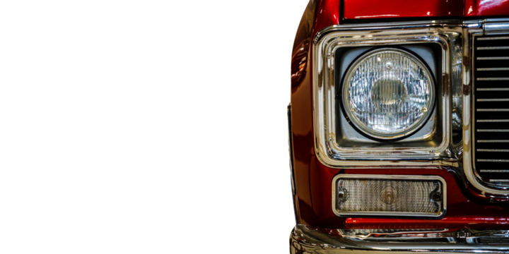 A close-up shot of the front of a bright red truck, with details visible on the bumper and grille