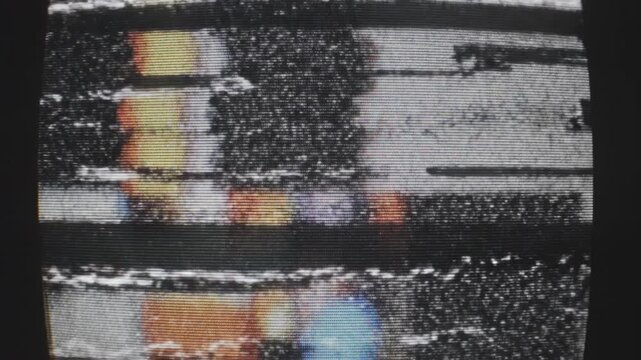 Static Screen: A close-up view of an old television screen, its surface riddled with a blizzard of static, disrupted signals, and broken lines.