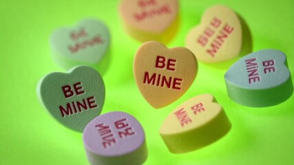 Sweethearts candies falling in a colorful swirl for Valentines, conveying love and romance with bright colors and a playful feeling of celebration