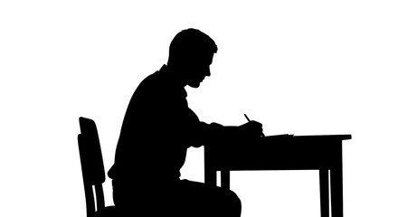Silhouette of person sitting at desk writing on paper with pen in black and white studio setting view