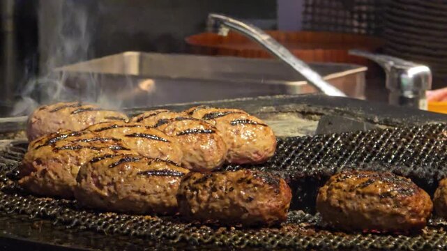 Hamburg steak patty searing on a hot barbecue grill