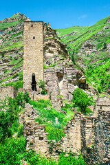An old watchtower among the ruins of the abandoned mountain village of Kakhib on a mountainside. North Caucasus