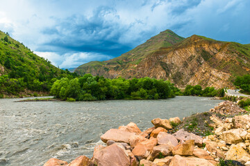 Picturesque landscape with a turbulent flow of a mountain river among beautiful mountains. North Caucasus