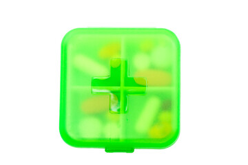 Green plastic pill container on white