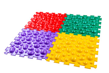 Multicolored foot massage mat on white