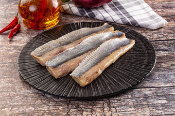 Marinated pickled salted herring fillet