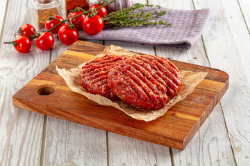 Raw uncoocked red beef round cutlet