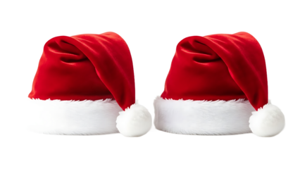 Two vibrant red and white Christmas hats with fluffy trim, perfectly isolated on a white background, representing festive holiday cheer and winter celebrations