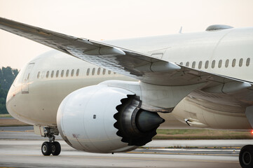 Close-up rear view turbofan engine mounted under the wing of wide body plane