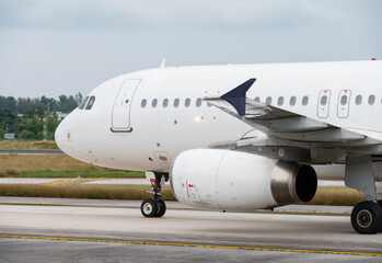 Narrow body jet airliner taxiing on the runway