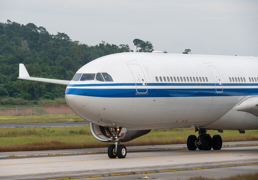 Close up of wide-body passenger plane taxiing on the runway
