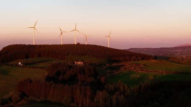 Aerial shot of wind power generators in rural setting. Green energy concept.