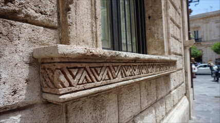 Ornate stone wall facade with historic architectural details.