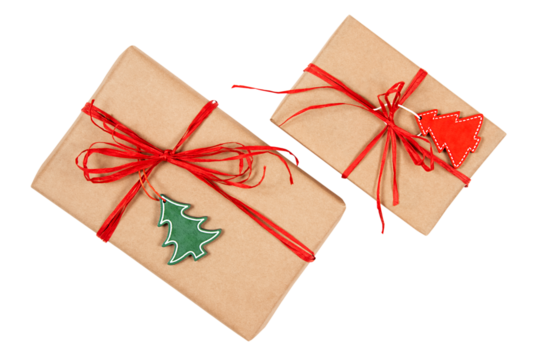 Two gift boxes made of brown kraft-paper with red ribbons and wooden tags shaped like Christmas trees.
