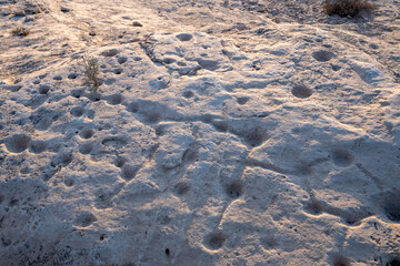 Doha, Qatar - November 05, 2025: Rock outcrop with ancient dot carvings at Jebel al Jassasiya site in Northern Qatar.