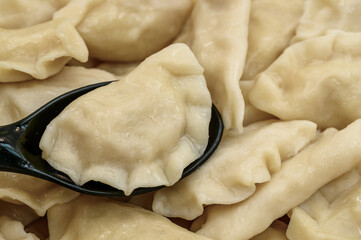 Boiled dumplings, boiled pierogi stuffed with filling, close-up