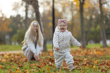 A beautiful woman walks in the park with a child 