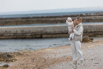 A beautiful woman walks in the park with a child 