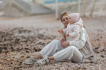 A beautiful woman walks in the park with a child 