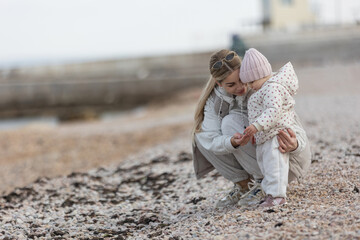 A beautiful woman walks in the park with a child 