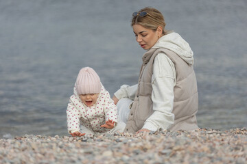A beautiful woman walks in the park with a child 