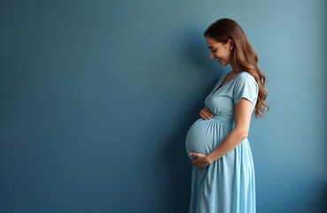 Smiling pregnant woman in light blue dress cradles her belly. Expectant mother experiences joy anticipation of new life. Healthcare wellness concept.