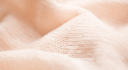 Soft Wool knitted background. Light pastel Alpaca wool mohair clothes texture closeup. Cashmere Soft and fluffy merino wool macro shot. Woolen fabric backdrop.