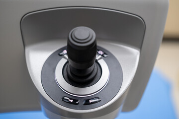 A close-up view of the ergonomic, high-precision joystick control interface used by the surgeon to manipulate and position the ZEISS Femtosecond Laser System during refractive eye surgery (SMI